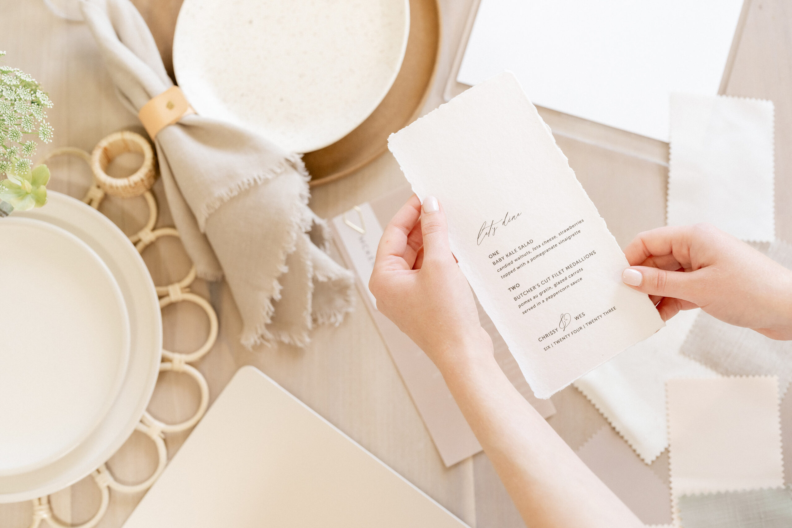 Bryce Gaston Events has a display of napkins, menu, stationery, chargers and other wedding tabletop decor items.